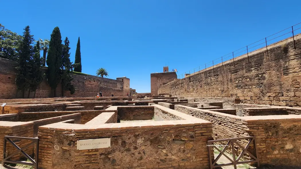 Alcazaba fortress in Alhambra surrounded by trees on a clear day