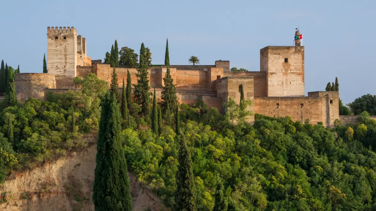 View of the Alcazaba fortress of the Alhambra surrounded by trees in Granada