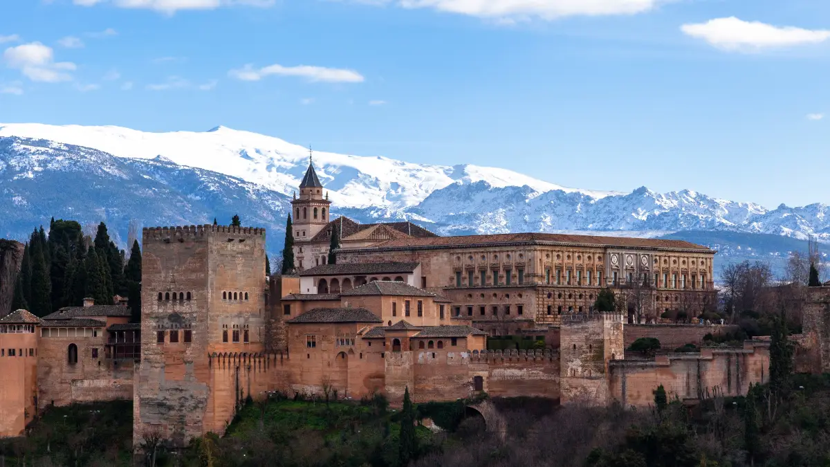 The majestic Alhambra Palace with the Sierra Nevada Mountains in the backdrop.