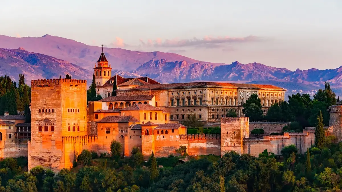 The stunning Alhambra Palace with the Sierra Nevada mountains backdrop The stunning Alhambra Palace with the Sierra Nevada mountains backdrop