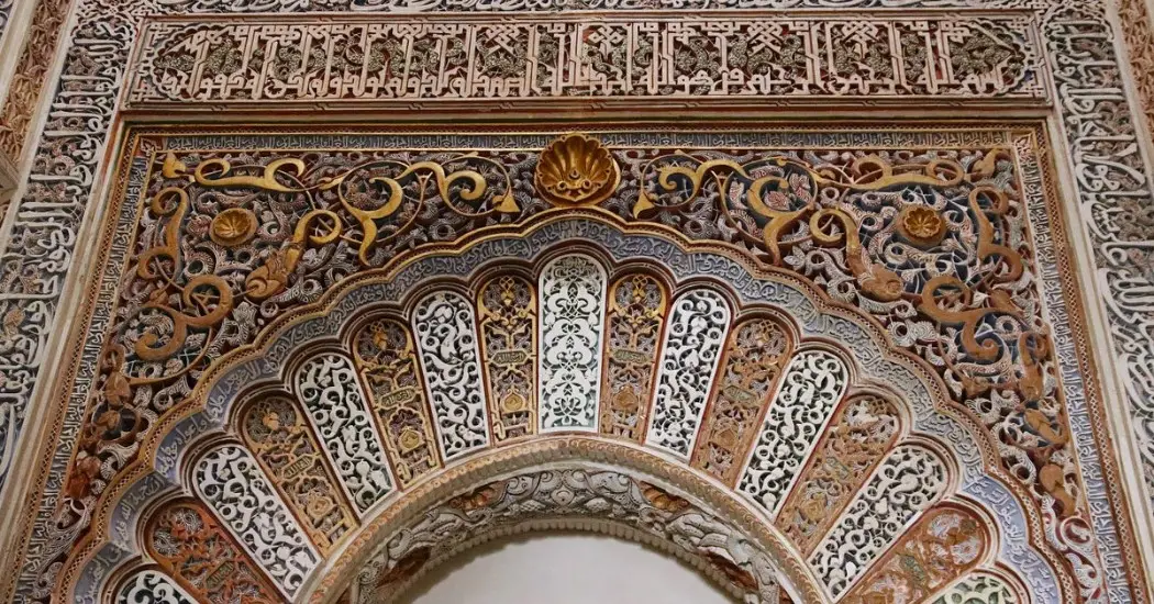 Detailed artwork of Islamic design in the arches of the Alhambra walls
