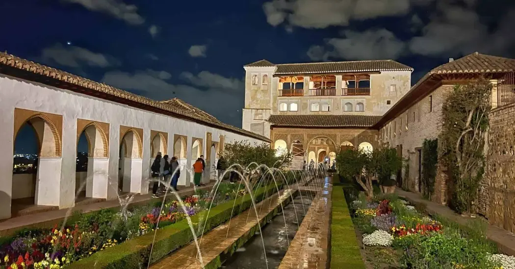 Tourists visiting the Generalife Gardens on a night tour